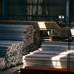 Stacks of metal billets inside an industrial steel manufacturing plant